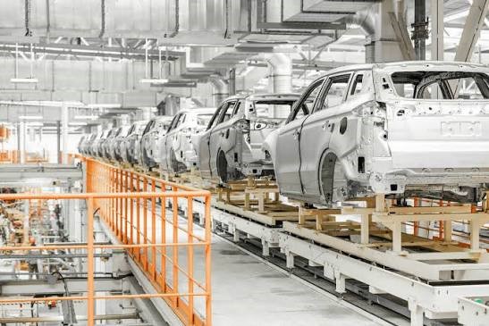 Robotic arms assembling car body on automated production line in European automotive plant